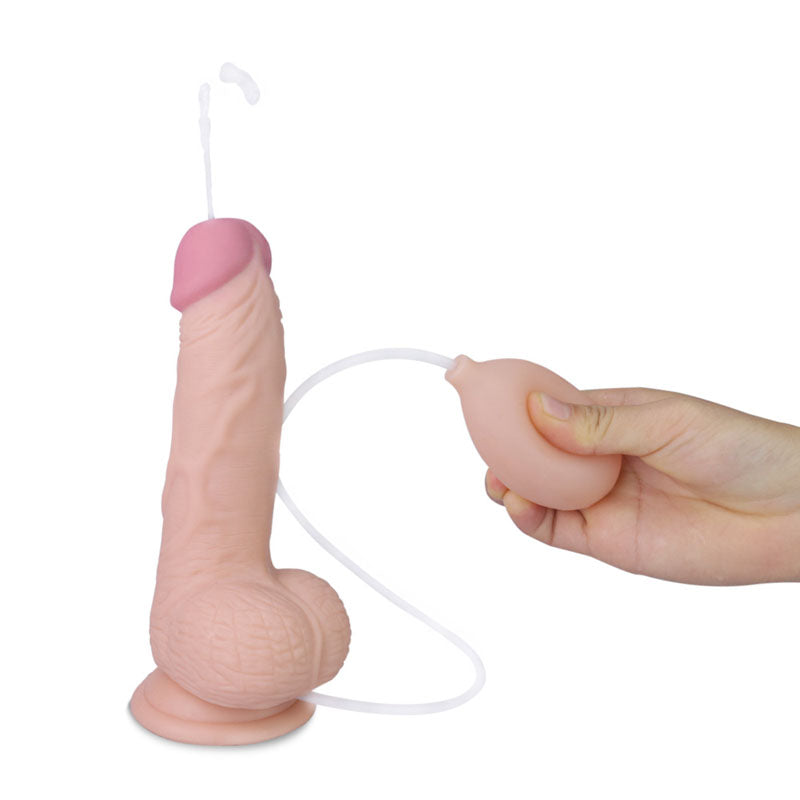 The Cumming Softee Soft Ejaculation Cock 8 with Balls is a realistic flesh-tone silicone dildo featuring a suction cup base and handheld squeeze pump that releases white liquid from the tip, simulating biological functions for squirting fun.