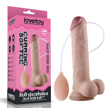 The product, Cumming Softee Soft Ejaculation Cock 9 with Balls - Flesh, is a boxed adult toy with a lifelike textured shaft and a squeeze bulb for simulated ejaculation. The packaging emphasizes its softness and squirting fun, using promotional graphics and text.