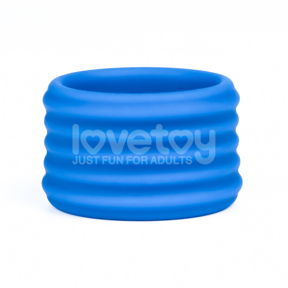 The Pinnacle Pro Deep Rib Grip - Blue Cock Ring is a blue, silicone ribbed cylindrical item with lovetoy JUST FUN FOR ADULTS on its side, featuring a wavy textured surface for firm grip, displayed standing upright against a plain white background.