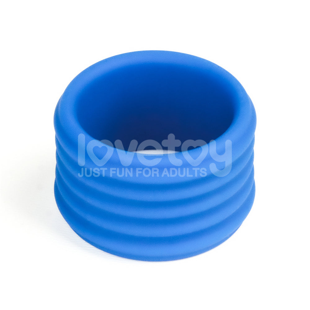 The Pinnacle Pro Deep Rib Grip - Blue Cock Ring features a blue ribbed silicone design with the brand name lovetoy and Just Fun For Adults. Its smooth finish and stacked ribs ensure a firm grip, all set against a plain white background.