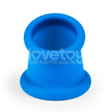 The Pinnacle Pro Tapered Squeeze, a blue silicone ball stretcher with a wide base and open top, features LoveToy Just Fun For Adults in white text above center. Ideal for enhancing playtime as a ball stretcher or penis ring against a bright white background.