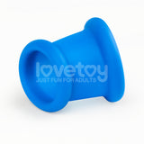 The Pinnacle Pro Tapered Squeeze - Blue Ball Stretcher is a blue silicone toy with a flared rim and concave base like a wide cylinder. The brand and tagline are in white text on the center of this smooth, matte penis ring, creating a striking contrast against the white background.