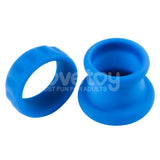 Against a white background, two vibrant blue Pinnacle Pro Twin Flex silicone rings are displayed. The left ring, ultra-flexible and slightly slimmer, features textured ridges. The right ring is wider with a flared base. Both ensure body-safe wear with their innovative Twin Flex Stretcher design.