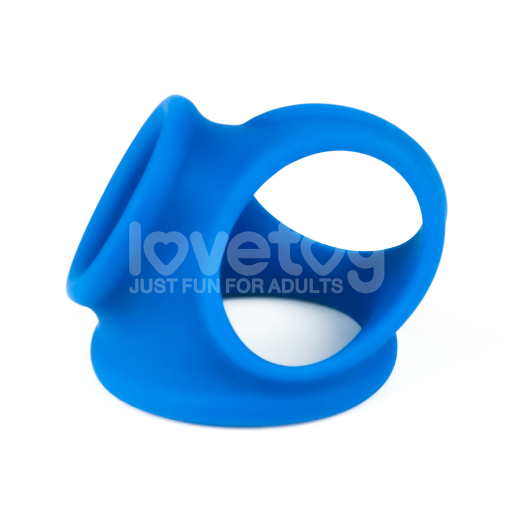 The Pinnacle Pro Trio Grip Enhancer - Blue Cock & Balls Ring features a unique triple-hole design with two circular openings connected by a short bridge, perfect for adult use. Made from premium silicone, it has the lovetoy brand and JUST FUN FOR ADULTS tagline, highlighting its smoothness and flexibility.