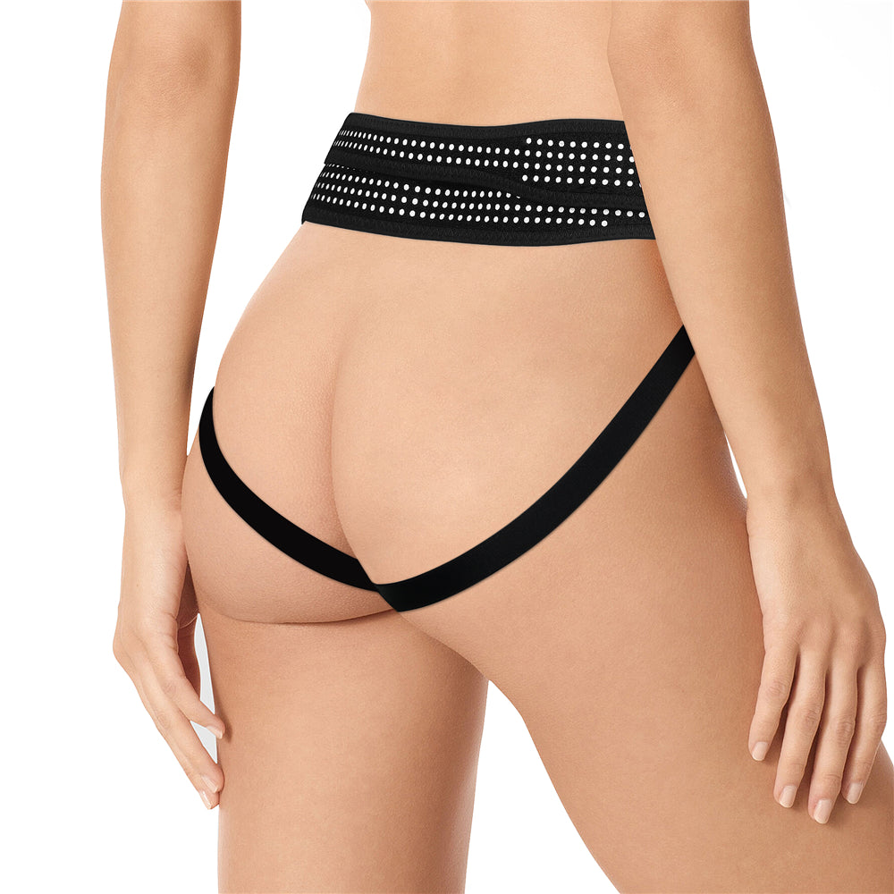 A person models the Ingen Easy Strap-On Harness, a black adjustable lingerie piece featuring stretchy webbing. The wide waistband with light dots and V-shaped lower straps accentuate the hips and back, showcasing its stylish fit. (Probe not included.).