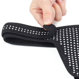 Someone adjusts the strap of an Ingen Easy Strap-On Harness in black. The padded, neoprene-like material with small white dots ensures comfort and support, while the Velcro closure provides a secure fit.