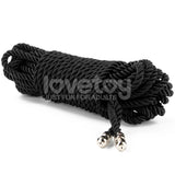 The Rebellion Reign Silky Bondage Rope, a sleek black 10-meter coiled rope with metal-tipped ends, elegantly rests against a white backdrop. Made from premium polyester, it subtly features lovetoy and JUST FUN FOR ADULTS across its surface.