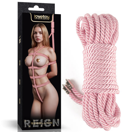 The Lovetoy Rebellion Reign Silky Bondage Rope in pink is showcased elegantly tied with a decorative pattern. A 10-metre length of silky rope, coiled neatly with metal tips, lies beside it, all set against the packagings stark black background emphasizing its luxurious design.