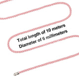 A pink rope with a silky finish and metal tip is arranged in a zigzag pattern. Bold black text reads: Total length of 10 meters above Diameter of 6 millimeters. Perfect for intricate bondage, this Rebellion Reign Silky Bondage Rope stands out against a white background.