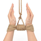 Hands bound with a rustic texture using Rebellion Reign Hemp Bondage Rope against a white background. The hands are positioned palms inward and slightly cupped, with the rope extending upward. The image features a watermark reading Loveboy Just Fun Products.