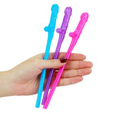 A hand holds three brightly colored Jokes & Parties Original Willy Straws with a wand-like design in blue, purple, and pink. Perfect for a hens night or festive occasion, these straws add magic to any event. The persons nails are painted dark red.