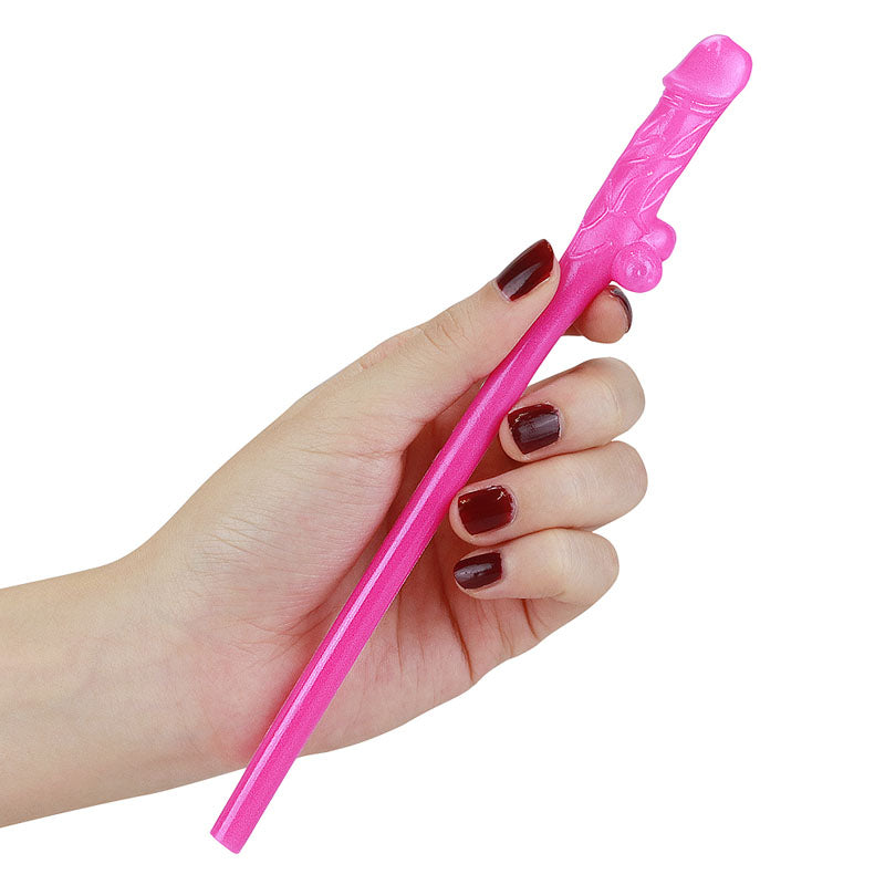 A hand with dark red nail polish holds a pink straw from the Jokes & Parties Original Willy Straws set, featuring textured details. The plain white background emphasizes the pecker-shaped design and hand, making it a fun accessory for any hens night celebration.