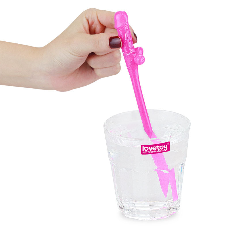 A hand with dark nail polish holds a pink ice mold above a branded lovetoy glass of water. This playful addition is ideal for enhancing hens night fun and perfectly complements the Jokes & Parties Original Willy Straws - Coloured Dicky Straws set.