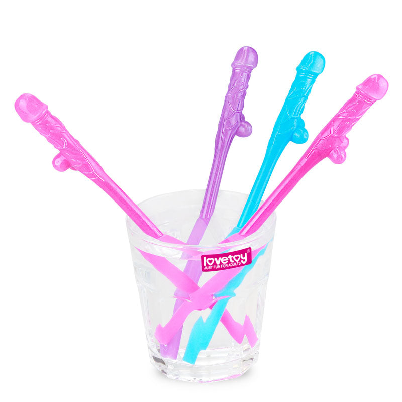 A clear glass holds a set of novelty Jokes & Parties Original Willy Straws, shaped like stylized male genitalia. Perfect for hens nights, it includes 9 colorful stirrers with detailed designs, arranged with handles partially visible, and features a pink logo with white text on the glass.