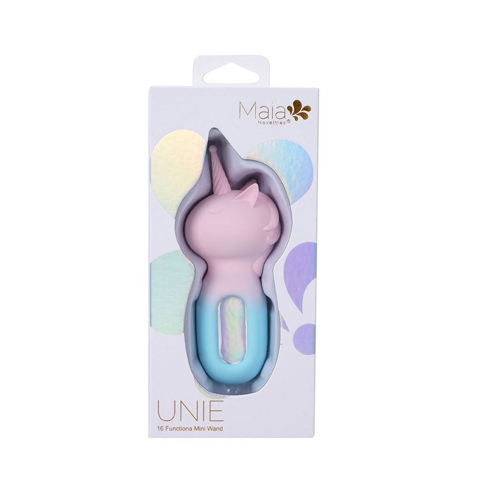 The image features the Maia UNIE - Pink/Blue USB Rechargeable Unicorn Wand packaging, displaying the unicorn design through a window. The box highlights its 16-vibrating functions, pink silhouette, light blue base, and silicone body with holographic brand accents.