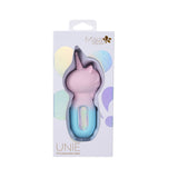 The image features the Maia UNIE - Pink/Blue USB Rechargeable Unicorn Wand packaging, displaying the unicorn design through a window. The box highlights its 16-vibrating functions, pink silhouette, light blue base, and silicone body with holographic brand accents.