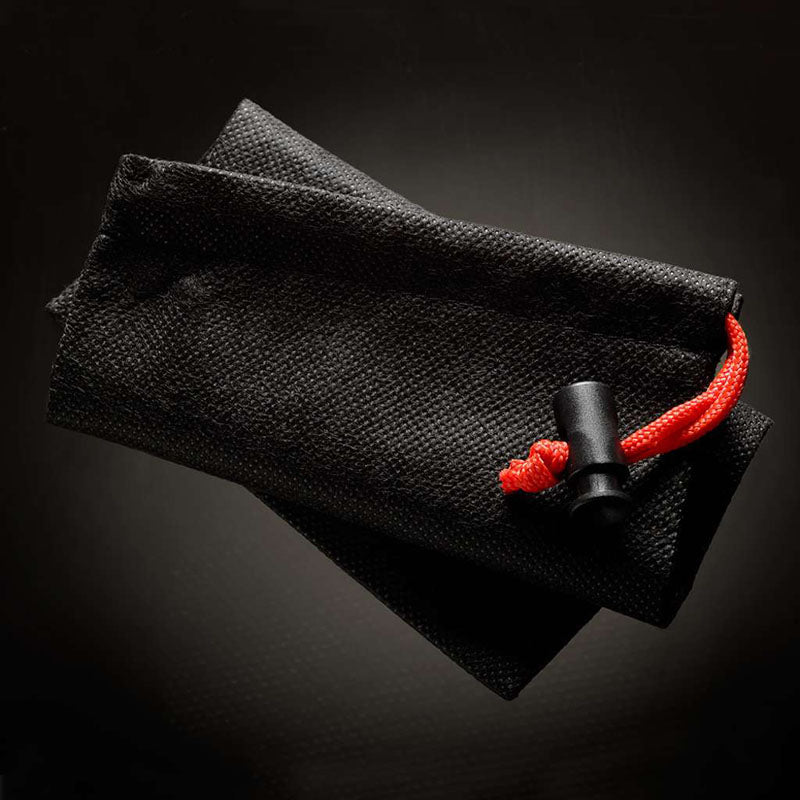 The MaleEdge Pro Kit, encased in a durable textured black pouch, is accentuated with a red drawstring and black clasp. Its slightly reflective material indicates robust construction, making it the perfect home for your MaleEdge Pro Kit - Penis Enlarger Kit in Red Case.