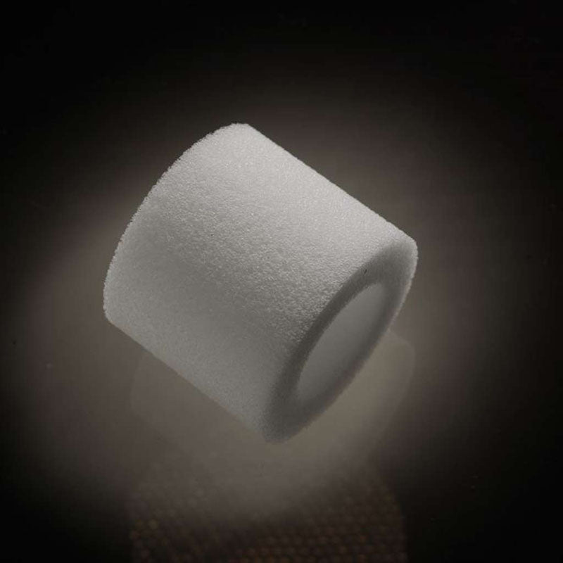 A close-up of a cylindrical white foam roller with a textured surface, similar to the MaleEdge Pro Kit - Penis Enlarger Kit in Red Case design, sits against a dark background. The dense yet lightweight foam is highlighted by soft lighting, showcasing its smooth edges and even cylindrical shape.