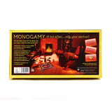 The back of the Monogamy - Adult Board Game box depicts an inviting scene: a dimly-lit living room, Monogamy game set up on the floor with red cards, wine glasses, and a cozy roaring fireplace promising an erotic fantasy with your partner.