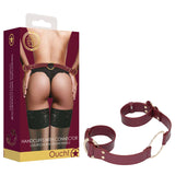 The packaging for the OUCH! Halo - Handcuff With Connector - Burgundy Restraint shows a model in black lace lingerie and stockings wearing the cuffs. Marketed as luxurious and fashionable, these handcuffs are an alluring addition to your BDSM kit for refined erotic pleasure.