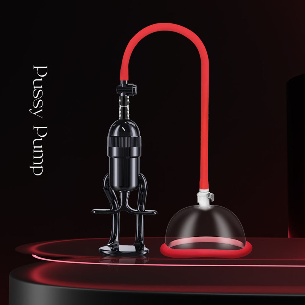 The LuvPump Vagina Enhancement System - Clear/Red Vagina Pump is displayed on a glossy red and black background, featuring a vagina enhancement tool with a black suction pump, a red flexible tube, and a clear suction cup made of medical-grade polycarbonate.