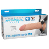 Packaging for the FX Elite 6 Silicone Hollow Strap-On in Flesh by Pipedream highlights the realistic device with adjustable straps, a soft head, and dual-density design. The box includes product dimensions and branding in the background.