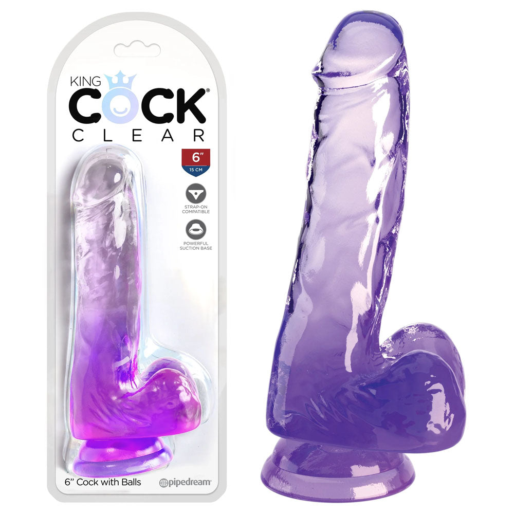 The image shows a translucent purple 6 King Cock Clear dildo, with balls, both packaged and unpackaged. It features a realistic design with veins, a strong suction cup base, and the package includes a crown graphic and @pipedream handle.