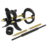 The LuvPump Max Fit Hybrid Penis Extender in black features adjustable components, a central frame with circular attachments, wing-like extensions, a black circular ring, two gold screws, and a black cylindrical rod with gold threaded ends.