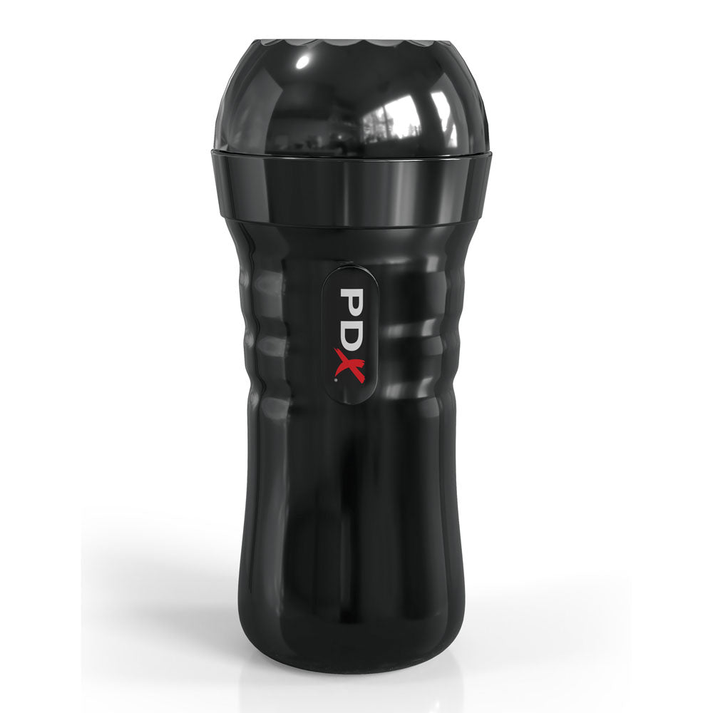 The product is a black, cylindrical Flesh Vagina Stroker resembling a portable cup. It has an ergonomic case with a textured grip and dome-shaped top. A vertical PDX label in white and red letters adorns the glossy surface, reflecting light against the plain white background.