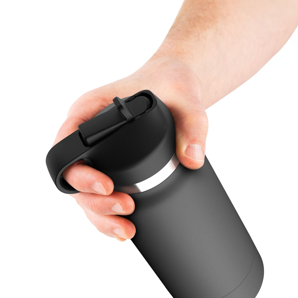 A close-up of a hand holding a sleek, matte black travel mug with a secure, looped lid resembles the realistic design of the PDX Plus Fuck Flask - Secret Delight, demonstrating how unexpected designs can offer realism much like this discreet vagina stroker.