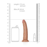 A tan, realistic silicone dildo, the REALROCK Realistic Slim Dildo without Balls, measuring 15.5 cm (6 inches) long and designed for g-spot stimulation, is shown with a suction cup between ruler guides. Silhouettes of a soda can and lipstick offer size comparison with rulers in inches and centimeters.