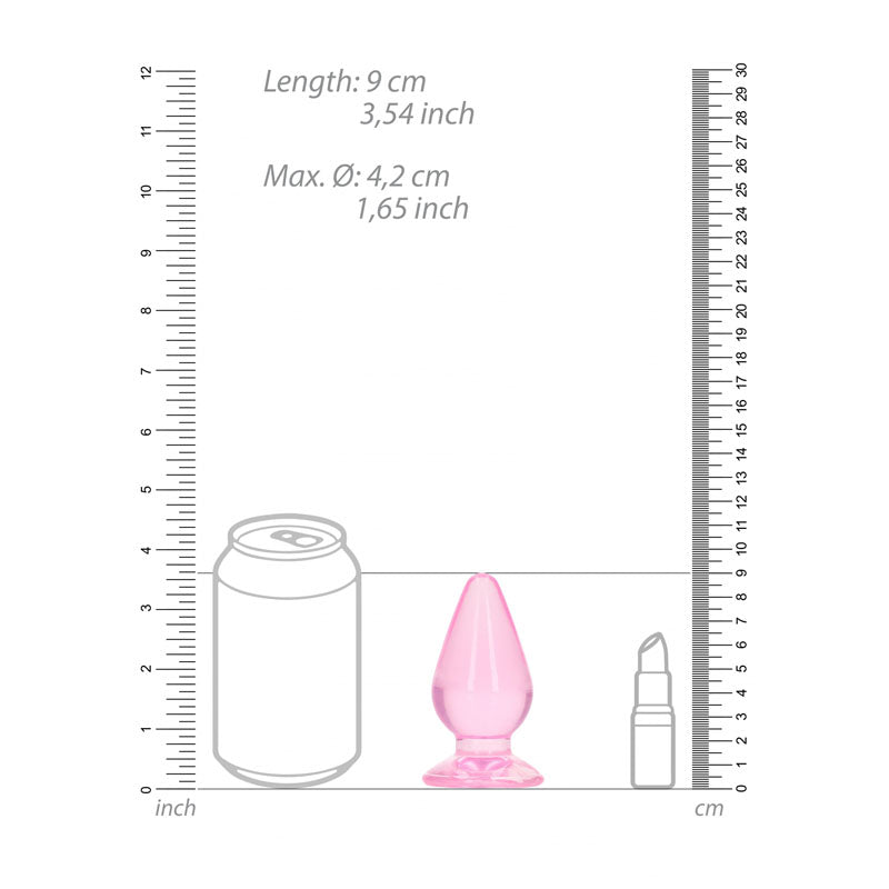 The image compares a REALROCK 9 cm Anal Plug in pink with a soda can and lipstick tube, framed by inch and centimeter rulers. This body-safe anal plug measures 9 cm (3.5 inches) long with a maximum diameter of 4.2 cm (1.65 inches).