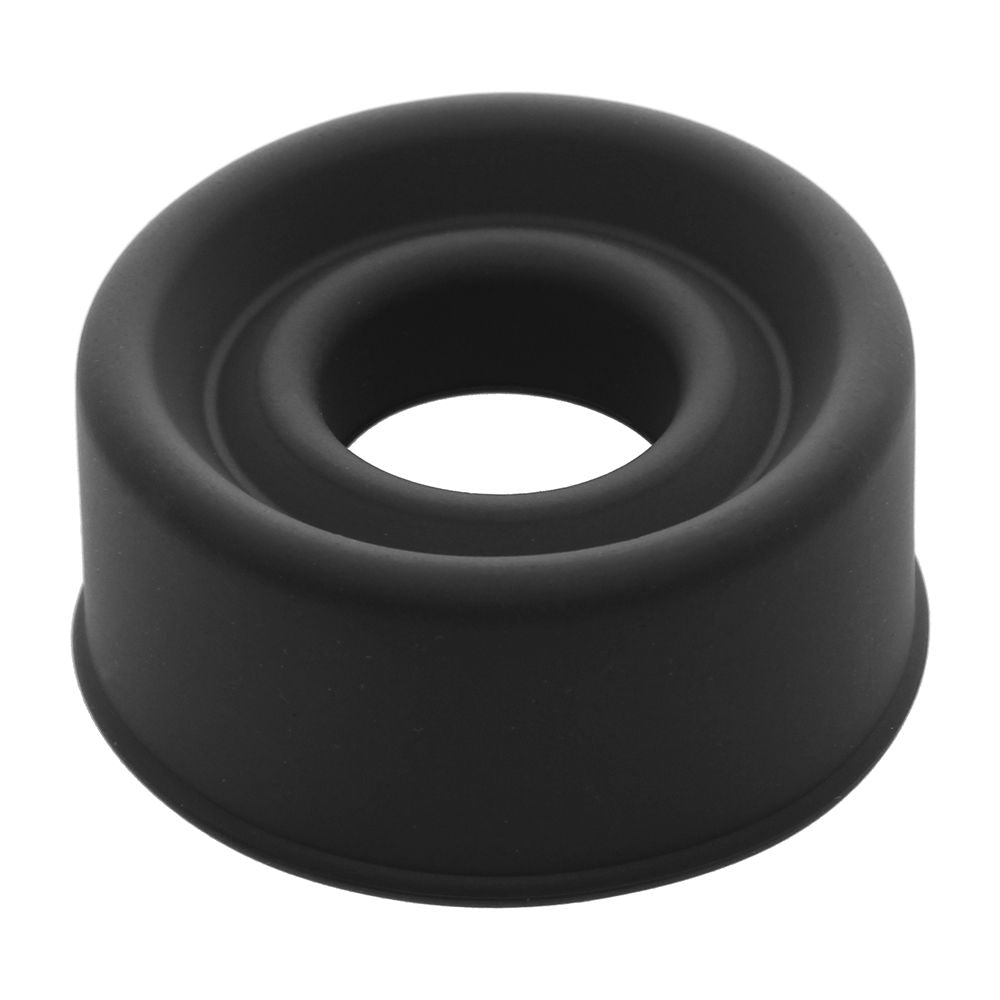 The LuvPump ComFit Silicone Sleeve in black features a round design with a slightly textured surface and a central cylindrical cavity, ideal for shaping. Its thick-walled structure includes a wide base and non-stick silicone finish, ensuring reliable use.