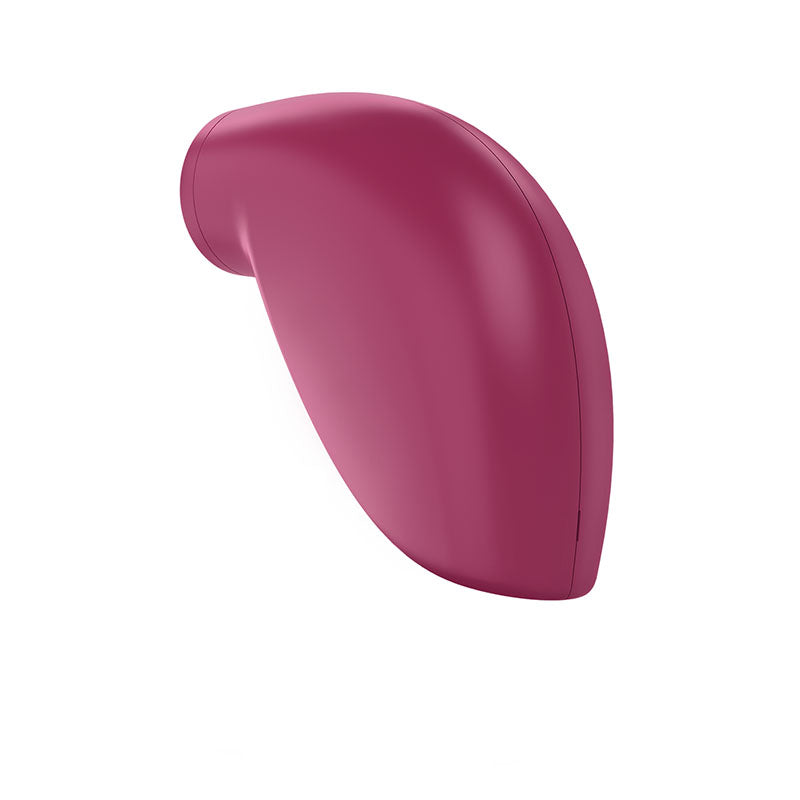 The Satisfyer One Night Stand, a touch-free disposable clitoral stimulator, features a pink, smooth silicone design reminiscent of a vertical raindrop. Its glossy surface subtly reflects light, offering discreet stimulation with varied vibration programs in a minimalist form without visible buttons.