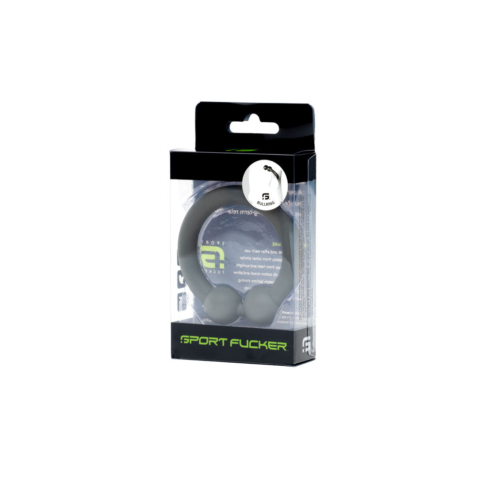 The clear package features a grey silicone Sport Fucker Bullring with 5 IN 1 pleasure highlighted at the top. The black and white design, accented with green, emphasizes the brands stylish and versatile allure of this cock ring.