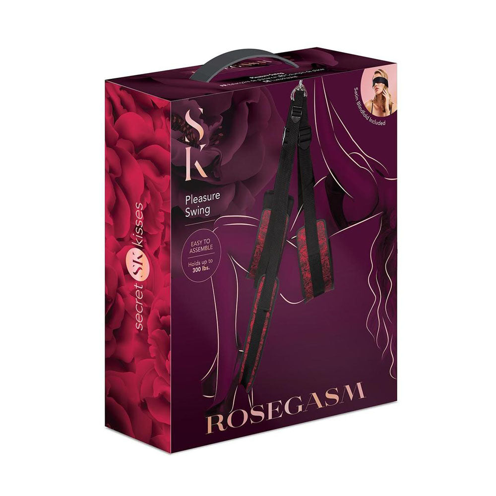 The Secret Kisses ROSEGASM PLEASURE SWING packaging features a dark burgundy box with rose patterns, showing black and red straps for partner play. Highlights include Easy to Assemble and Holds up to 300 lbs. A cutout reveals a blindfolded person enhancing exploration of erogenous zones.