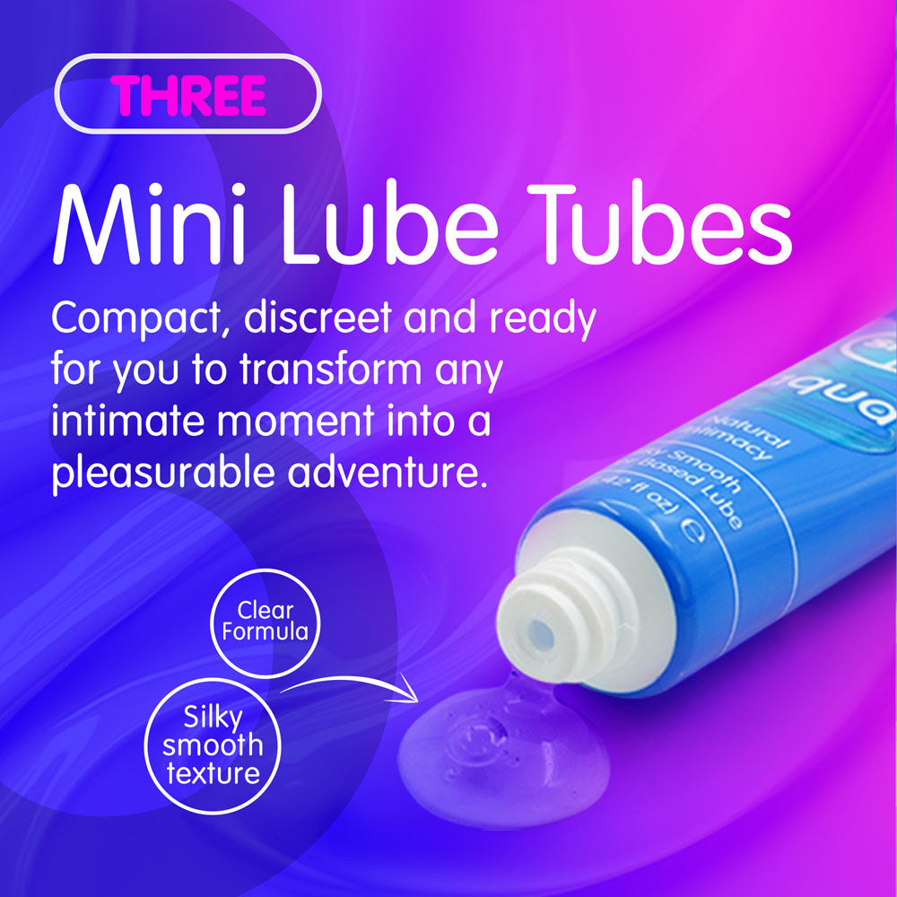 The image features a purple and blue gradient with THREE Mini Lube Tubes in white and pink text. A blue tube shows a clear, silky gel emphasizing its Clear Formula. These 12 ml Skins Fruity Tubes come in Watermelon, Strawberry, & Mango & Passionfruit flavors, are vegan-friendly, and water-based for smoothness.