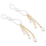 The Sex & Mischief Pearl Nipple Ties - Gold/Pearl Nipple Restraints set includes two gold pieces with looped white bands and faux pearl accents, featuring three dangling chains with small pearls for a sophisticated look.