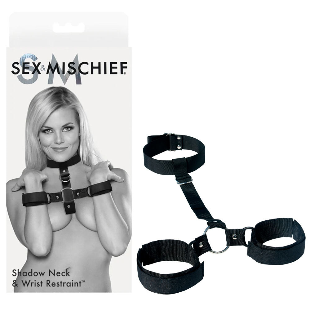 The image displays the Sex & Mischief Shadow Neck and Wrist Restraint featuring a model showcasing adjustable bondage restraints ideal for BDSM beginners. The sleek black design includes a collar and wrist straps linked by a short strap, all part of the renowned Sex & Mischief brand.