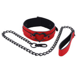 Discover the Sex & Mischief Amor Collar and Leash - a stylish red vegan leather accessory with a black heart-shaped buckle, soft lining, and secure clasp. The set includes a matching red handle and black chain leash for comfort and style.