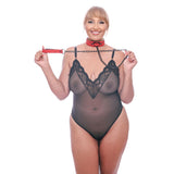 A smiling person in sheer black lingerie with lace and polka dots wears a Sex & Mischief Amor Collar and red vegan leather chain leash, highlighting their short blonde hair against a plain white background.