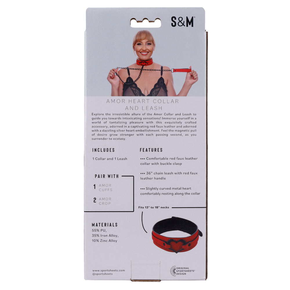 The packaging features a woman with a red vegan leather collar and leash adorned with black heart accents. The Sex & Mischief Amor Collar and Leash - Red Restraint set boasts adjustable vegan leather with a robust buckle, cuffs, and crop. Branding and dimensions are included.