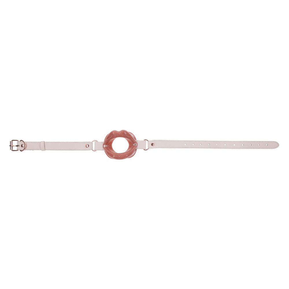 A beige faux leather belt with a large pink circular knot-like buckle features adjustable holes and a silver clasp, offering a minimalistic modern design to elevate fashion-forward looks in intimate moments.