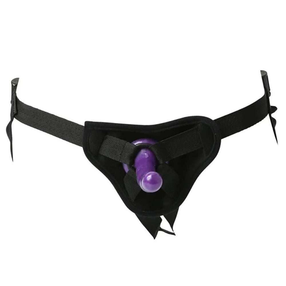 The Sex & Mischief Strap-On & Silicone Dildo Kit features a black harness with adjustable straps and a central purple silicone dildo. The minimal design includes a rounded front panel and buckle straps for comfort, ease of use, and secure fit.