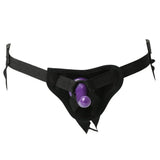 The Sex & Mischief Strap-On & Silicone Dildo Kit features a black harness with adjustable straps and a central purple silicone dildo. The minimal design includes a rounded front panel and buckle straps for comfort, ease of use, and secure fit.