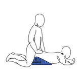 Two stylized figures, one kneeling behind the other, are illustrated in an intimate position. The front figure is supported by a Pivot Positioner - Black Foam Position Cushion shaped like a blue triangle. Both minimalistic figures are gender-neutral against a white backdrop.