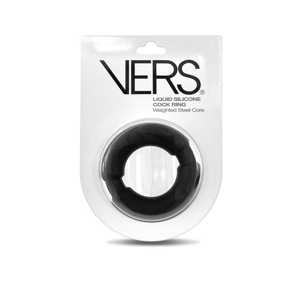 The VERS Liquid Silicone Weighted Steel Core C-Ring for enhanced sexual performance is packaged on a white card with LIQUID SILICONE COCK RING Weighted Steel Core in bold black text. The black cock ring, featuring a steel core, is encased in clear plastic and attached to the product card.