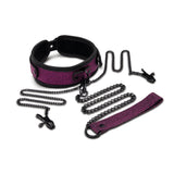 The WhipSmart Dragons Lair Set in purple/black includes a padded, adjustable collar, leash, and wrist restraints with matching detachable chains and clasps. The textured fabric adds style, making it ideal for versatile BDSM encounters.