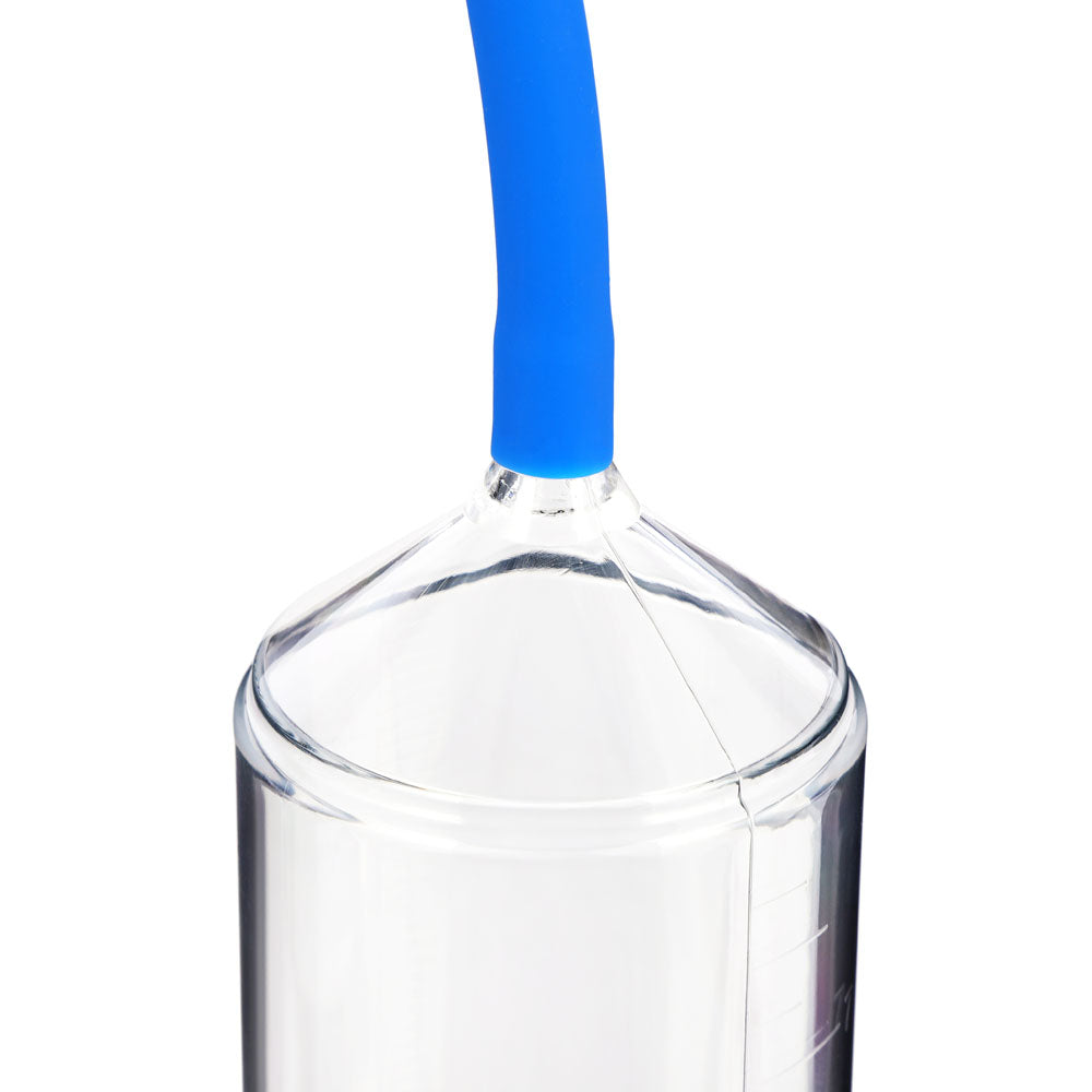 The LuvPump ProXtra Professional Gauge Power Pump, a clear cylindrical glass device with a smooth finish, features a blue rubber tube for liquid transfer, enhanced by an attached pressure gauge for precision.