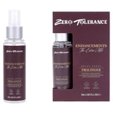 The Zero Tolerance Enhancements - The Extra Mile Delay Spray for Men, 60 ml, comes in a clear spray bottle with a brown label displaying Zero Tolerance and Enhancements, The Extra Mile. Packaged with a matching box, it features Delay Spray and Prolonger, offering stamina enhancement instructions.